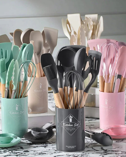 Set of kitchen utensils in colorful holders on a table.