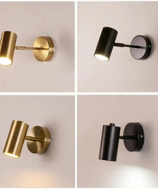 Two gold and two black wall sconces on a light gray background