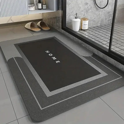 Gray bath mat with 'HOME' text on a bathroom floor
