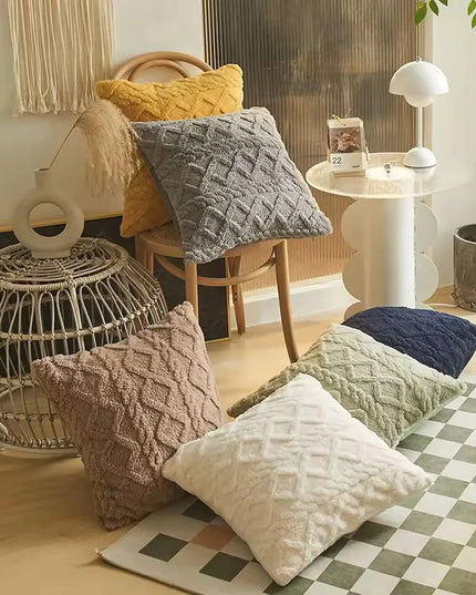Living room with textured pillows on a checkered rug, wicker basket, and small table.