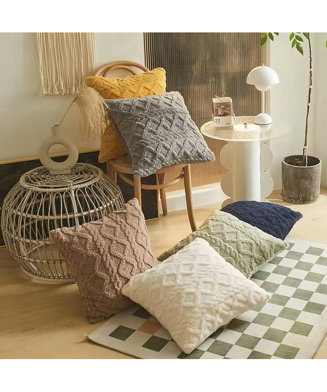 Living room with textured pillows on a checkered rug, wicker basket, and small table.