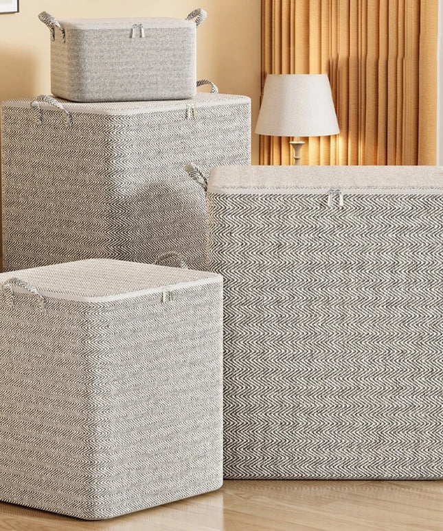 Set of gray storage baskets with lids on a wooden floor.