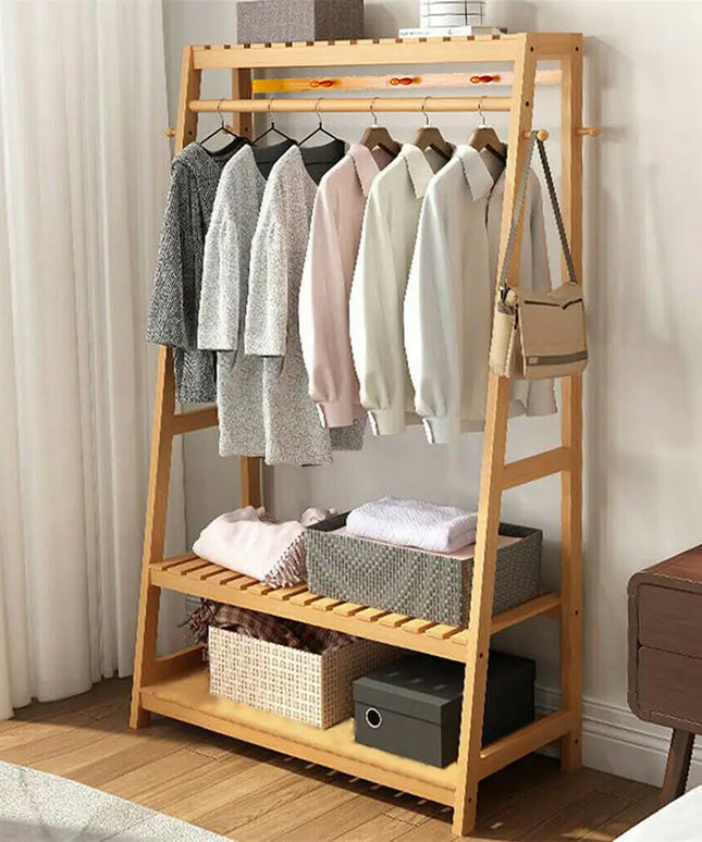 Wooden clothing rack with clothes and storage baskets in a room.