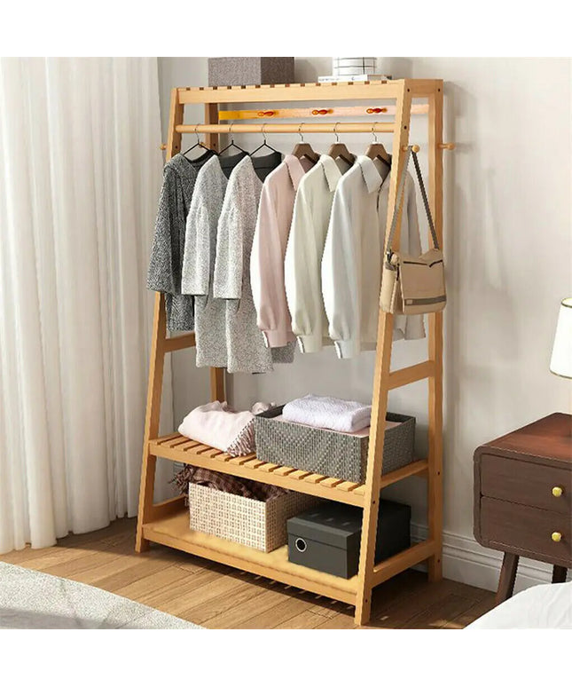 Wooden clothing rack with clothes and storage baskets in a room.