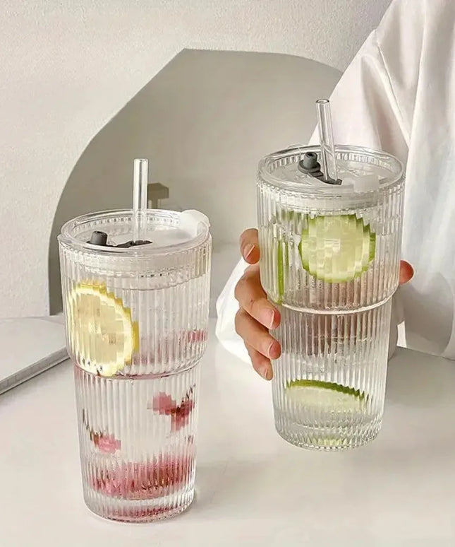 Two clear tumblers with lemon and lime slices on a light surface.