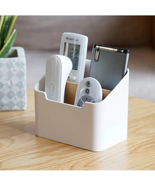 White remote control holder with electronic devices on a wooden surface