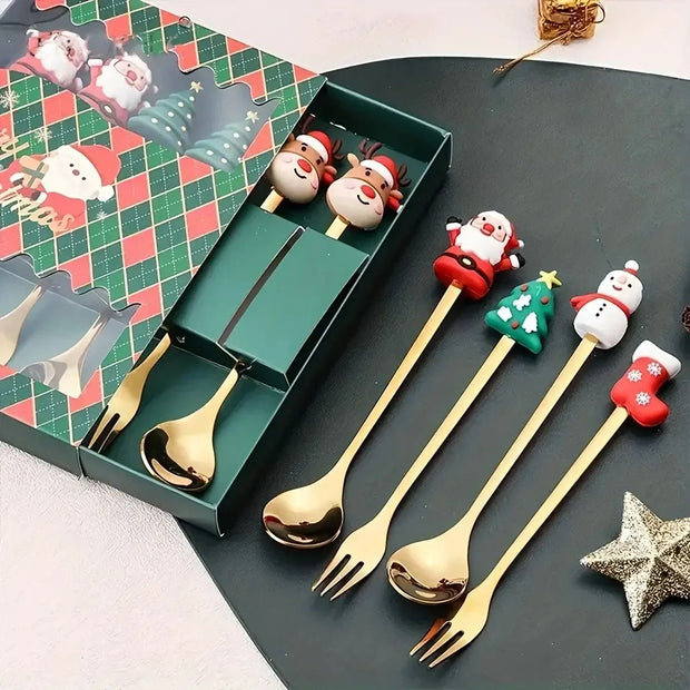 Set of Christmas-themed gold cutlery with decorative handles on a dark surface.