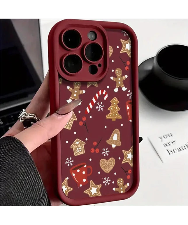 Phone case with Christmas-themed design held by a hand, with a blurred background