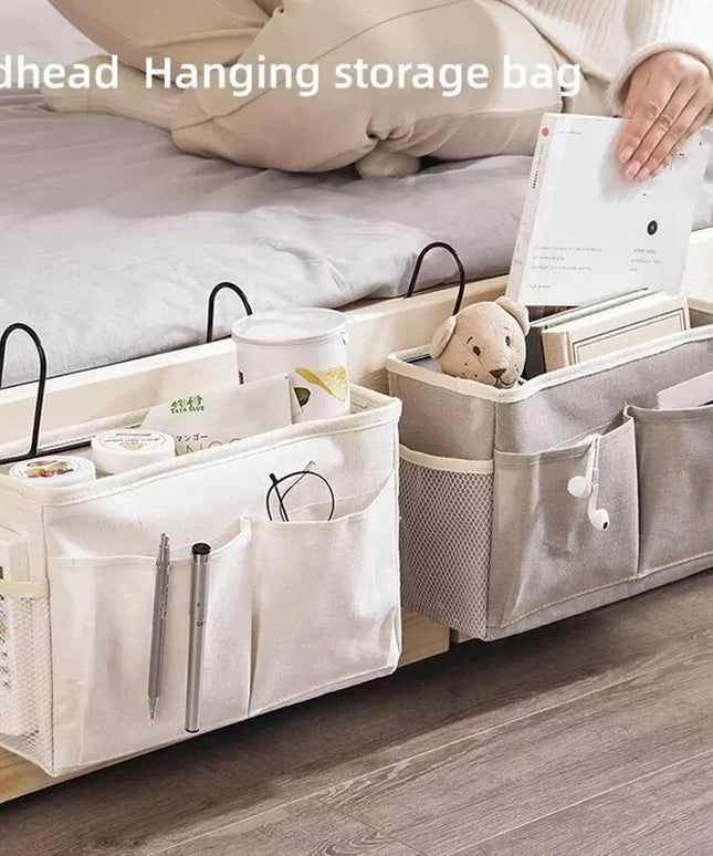 Bedhead hanging storage bag with various items on a bed