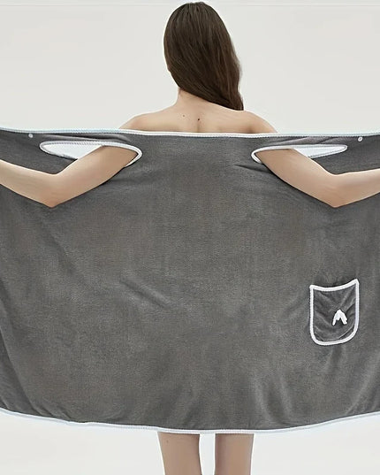 Person holding a large gray towel with a pocket on a white background